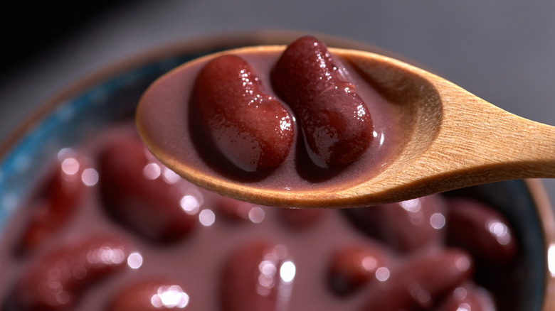 Plump red kidney beans on wooden spoon