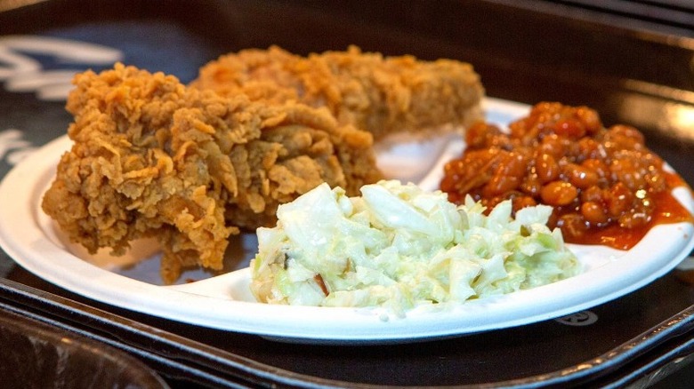 Plate with fried chicken, baked beans, and cole slaw