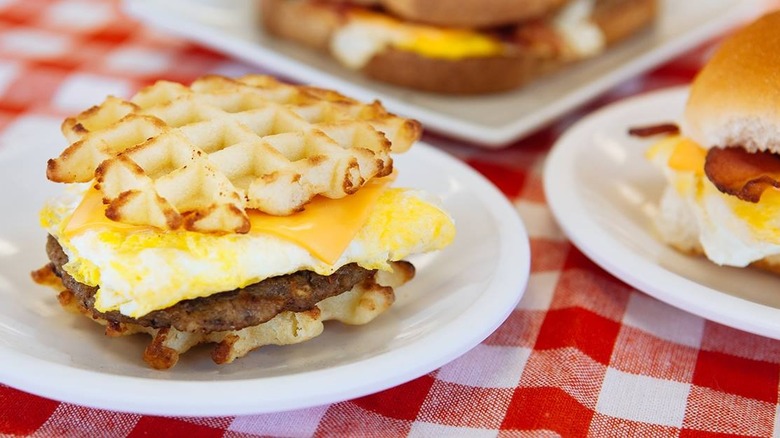 Breakfast sandwiches on white plates