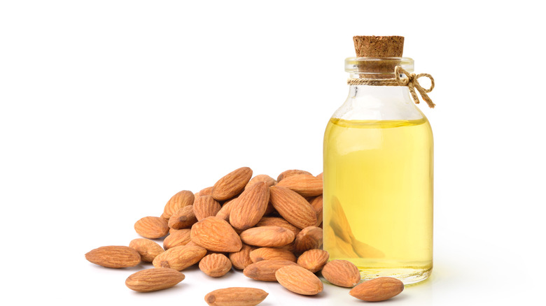 almond oil next to dried almonds