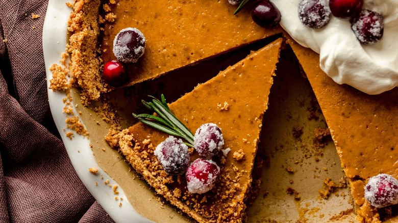 Pumpkin pie with a graham cracker crust in a festive setting