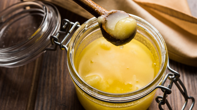 Jar of clarified butter with scoop