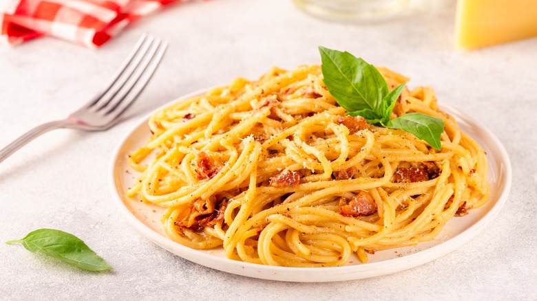 Bucatini carbonara on white dish