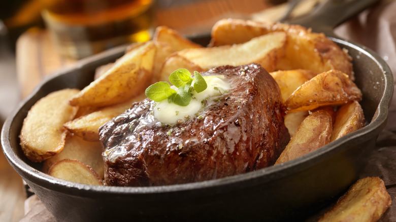 Steak in a pan with steak cut fries