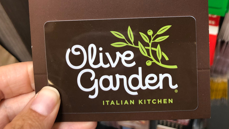 Person holding Olive Garden gift card