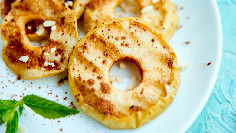 grilled apples with cinnamon on white plate