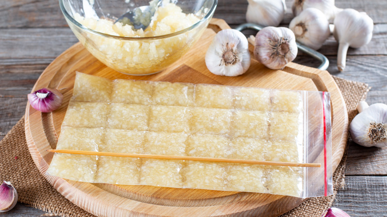 Frozen minced garlic in ziploc bag on cutting board