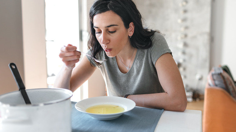 woman eating soup