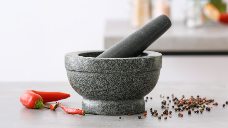 mortar and pestle with peppercorns