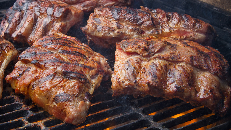 Pork ribs grilling over fire