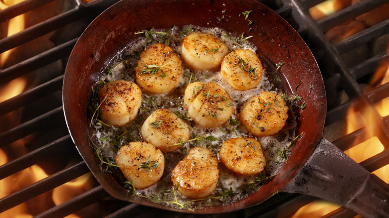 Scallops being pan fried 