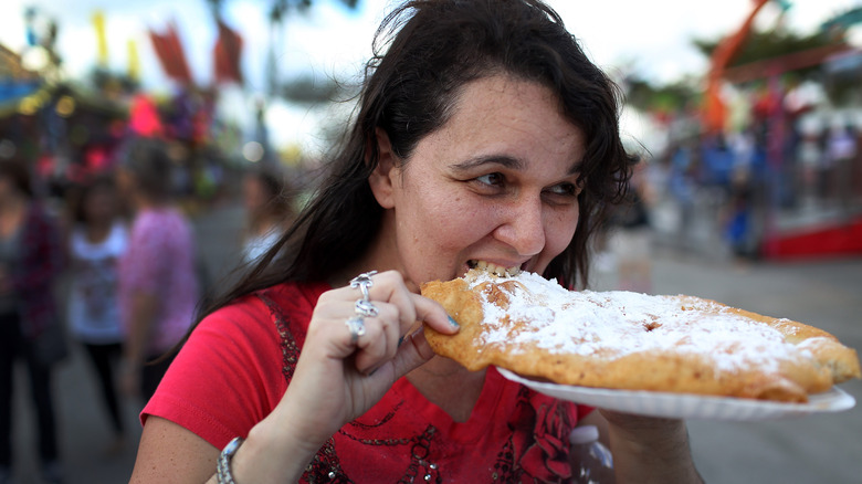 Woman eating funnel cake