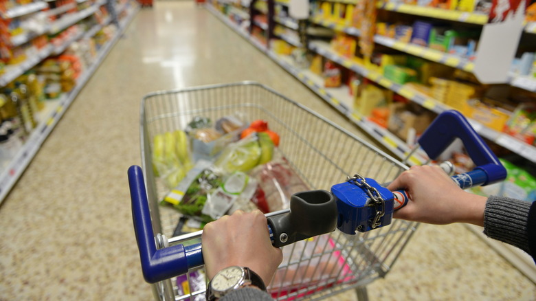 Aldi shopper with cart in grocery aisle