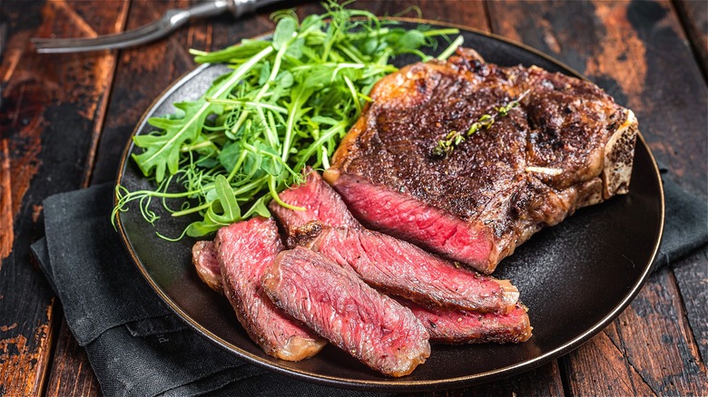 Sliced seared steak with greens