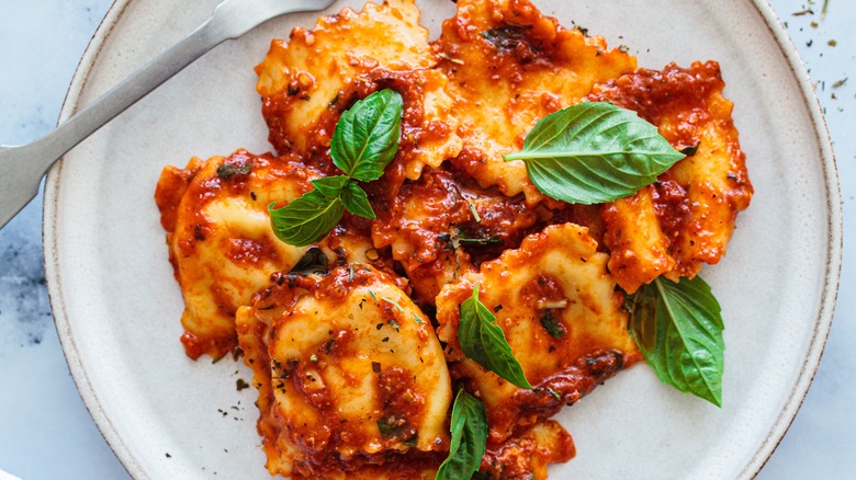 Ravioli with sauce and basil