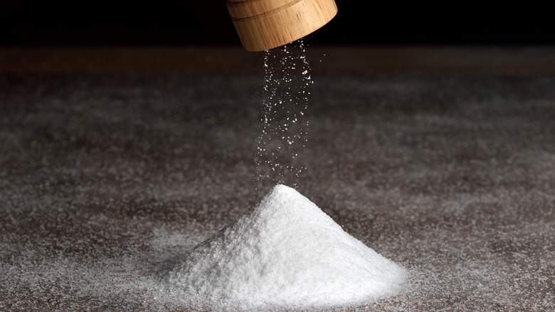 Salt grinder and a pile of salt