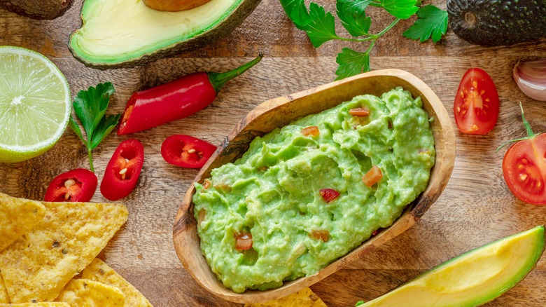 Guacamole with tomatoes in bowl
