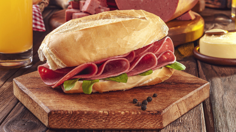 Bologna sandwich on wood plate
