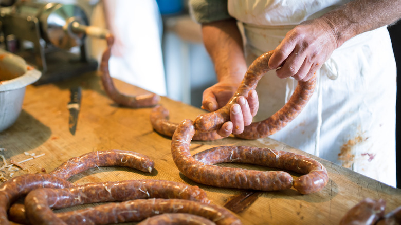 butcher filling sausages