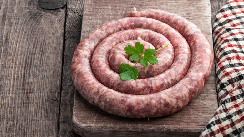 sausage coiled on wooden board