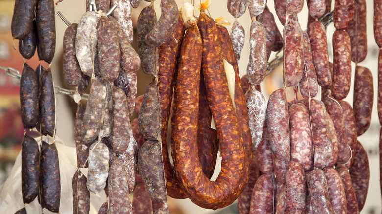 variety of hanging sausages