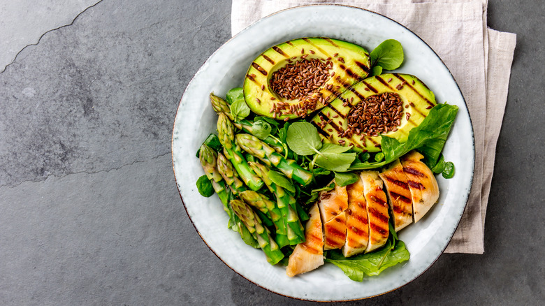 Dish of grilled avocado, chicken and asparagus
