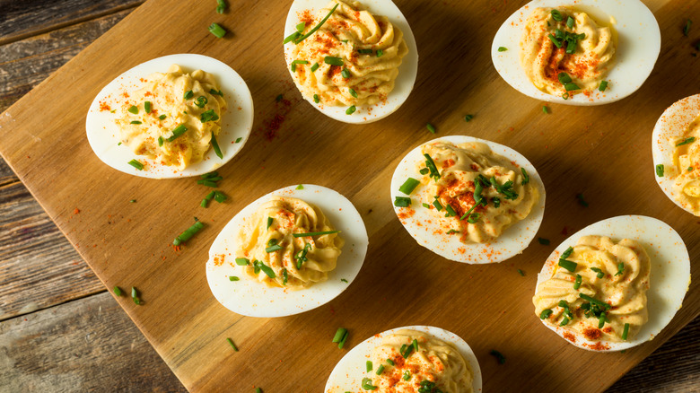 deviled eggs on cutting board