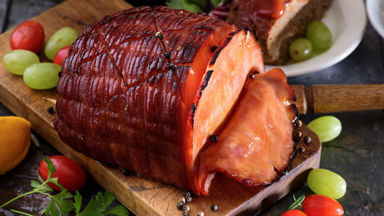 juicy baked ham on board