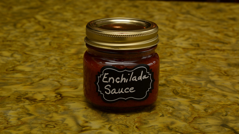 A glass jar of enchilada sauce