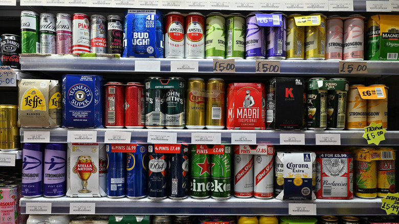 Beers in cans on a grocery store shelf 