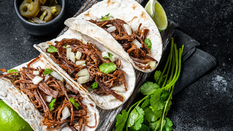 Carnitas tacos with cilantro, jalapenos and lime