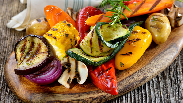 grilled mixed veggies beautifully displayed on wooden serving tray