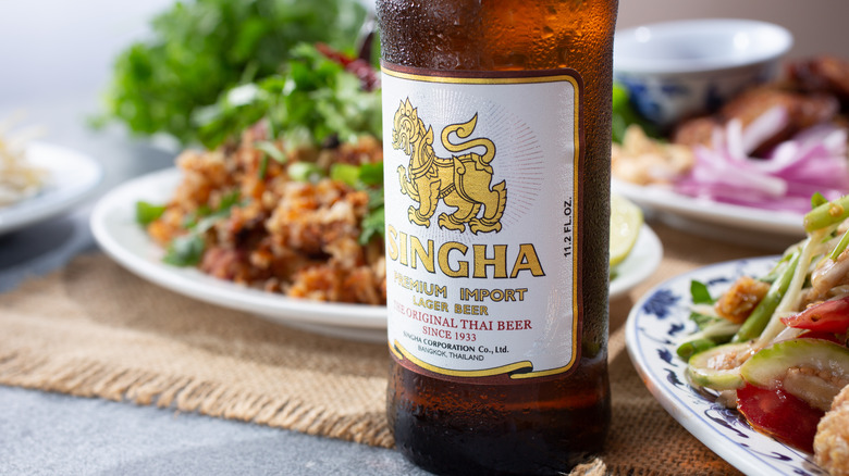 bottle of singha beer with thai food