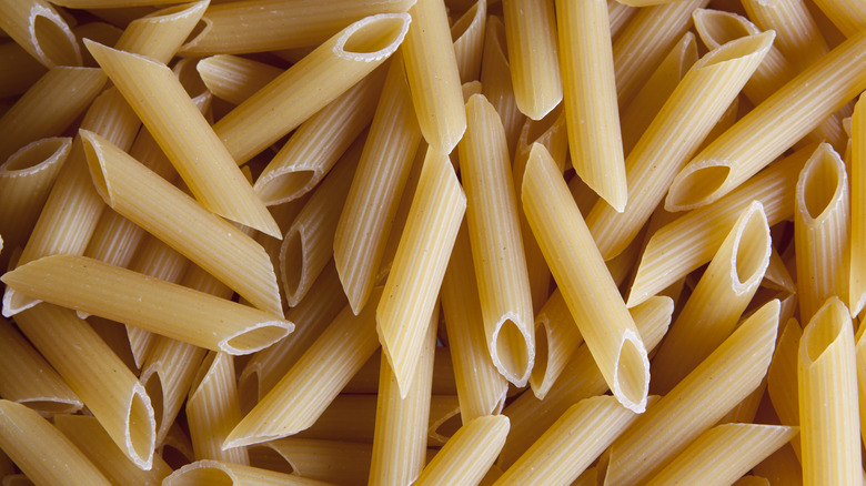 Dried uncooked penne pasta noodles
