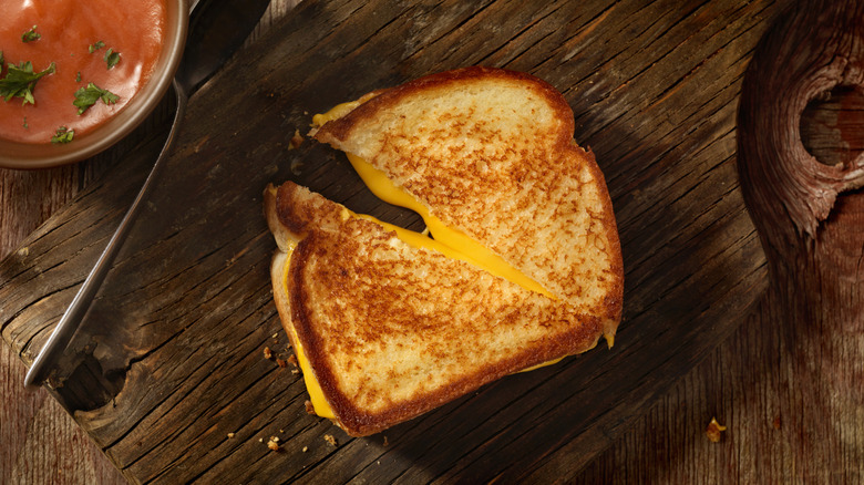 Melty grilled cheese on wooden board