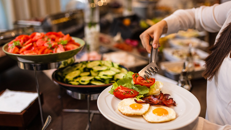 person serving from breakfast buffet