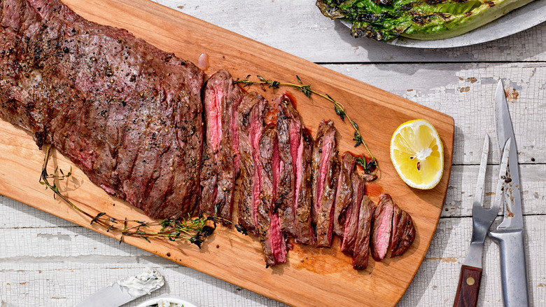 Sliced skirt steak on board