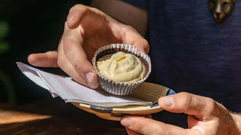 Person holding a tiny dessert