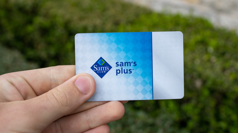 Person holding a Sam's Club membership card