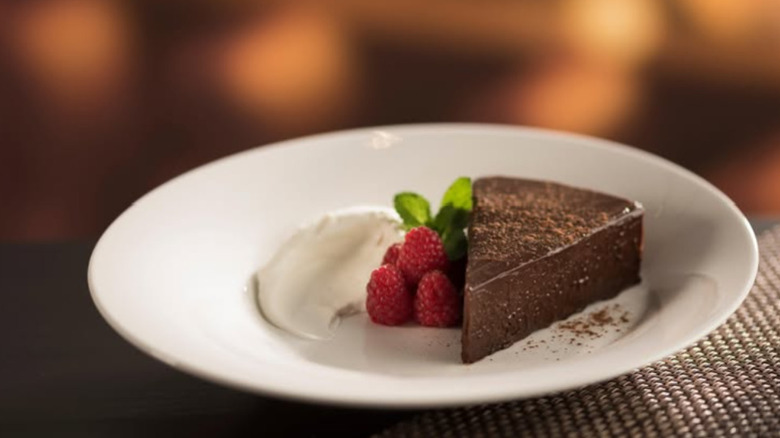 Flourless Chocolate Espresso Cake slice with raspberries on a plate