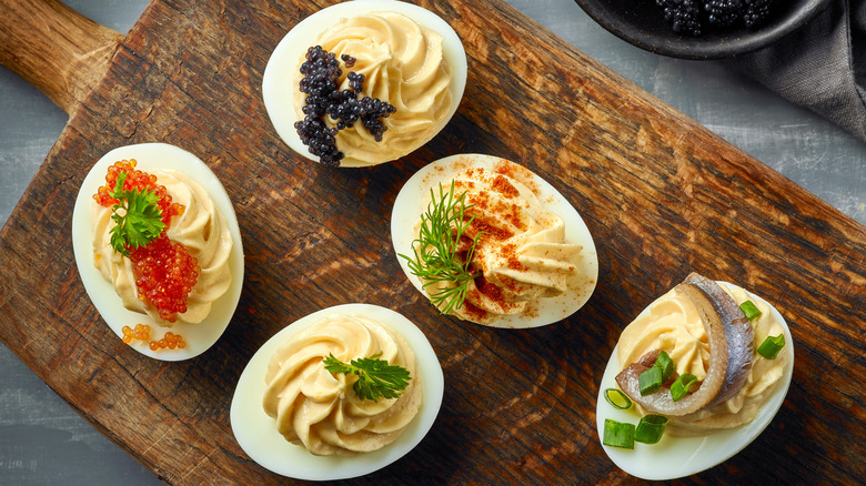 Deviled eggs topped with various garnishes