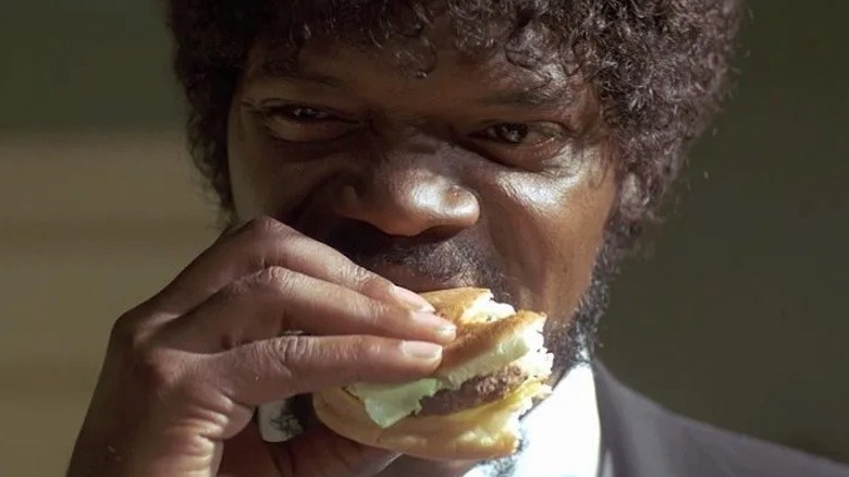 Man takes bite of a burger