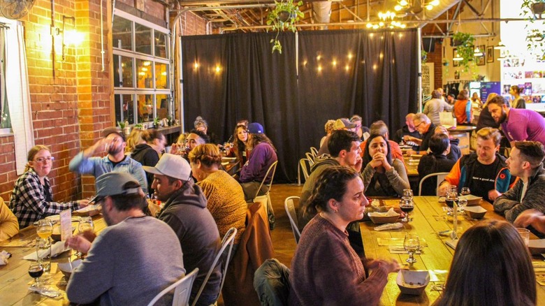 Customers sitting around tables drinking