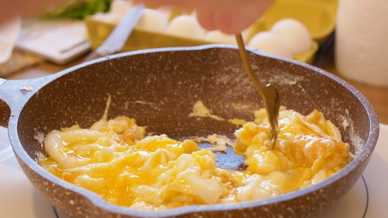 Soft scrambled eggs in pan 