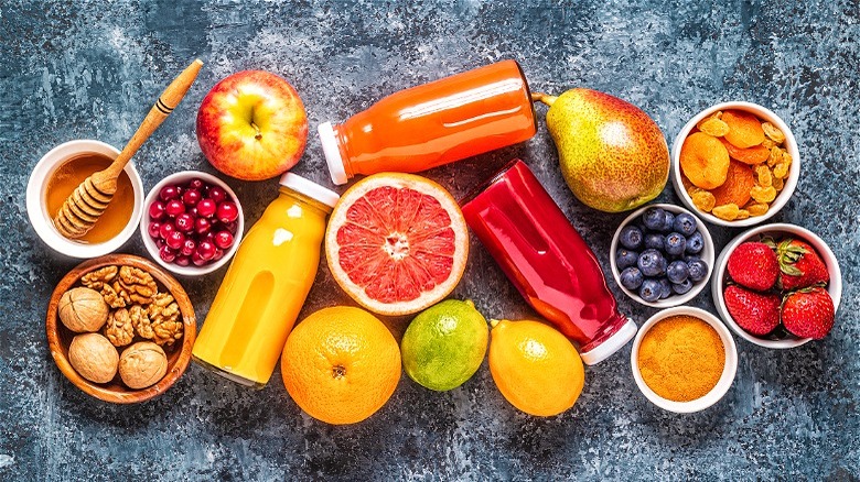 Bottles of juice and whole fruits 