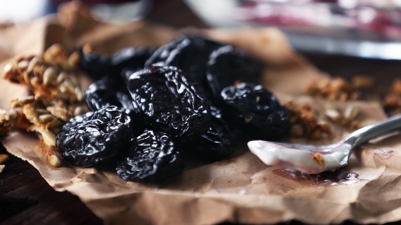 dried prunes next to spoon