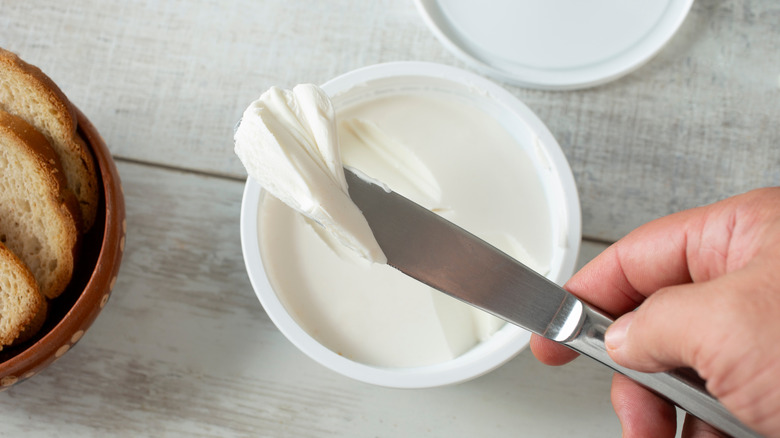 cream cheese container and knife