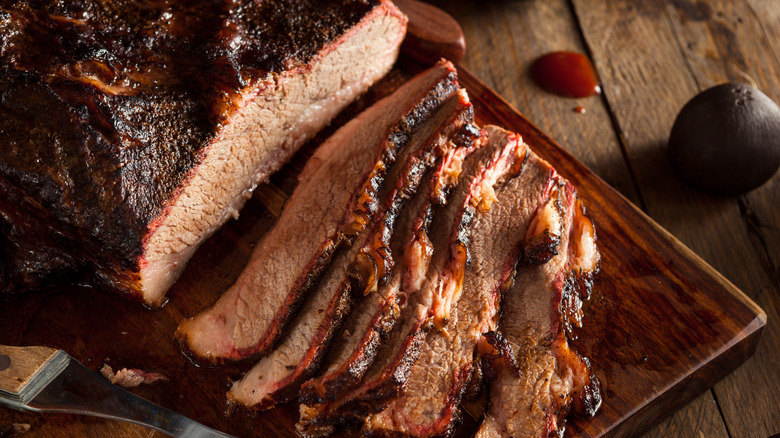 Sliced beef brisket on a wooden board