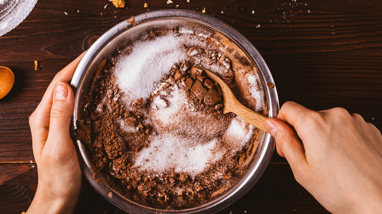 hand mixing dough wooden spoon