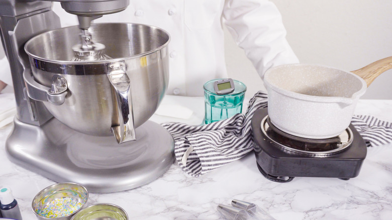 mixer and pan on heat making frosting